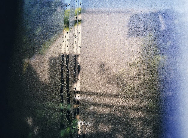 Water droplets running down inside of window