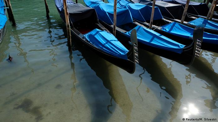 Gondolas on the clear waters of Venice canals 